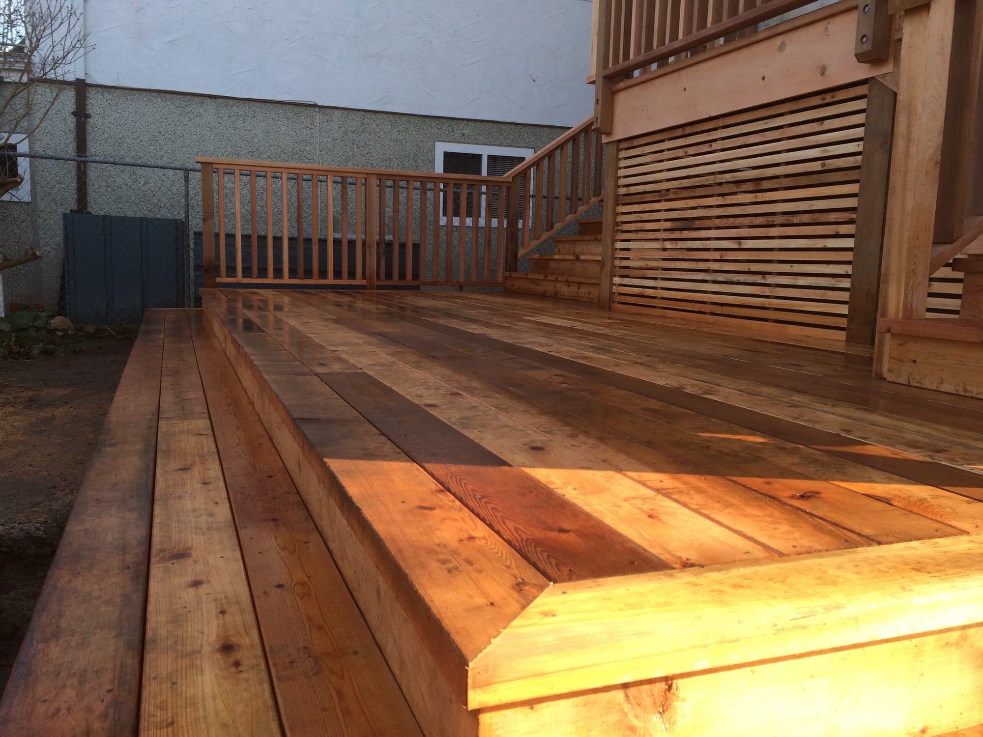 New cedar deck, stairs and railing glowing in evening light